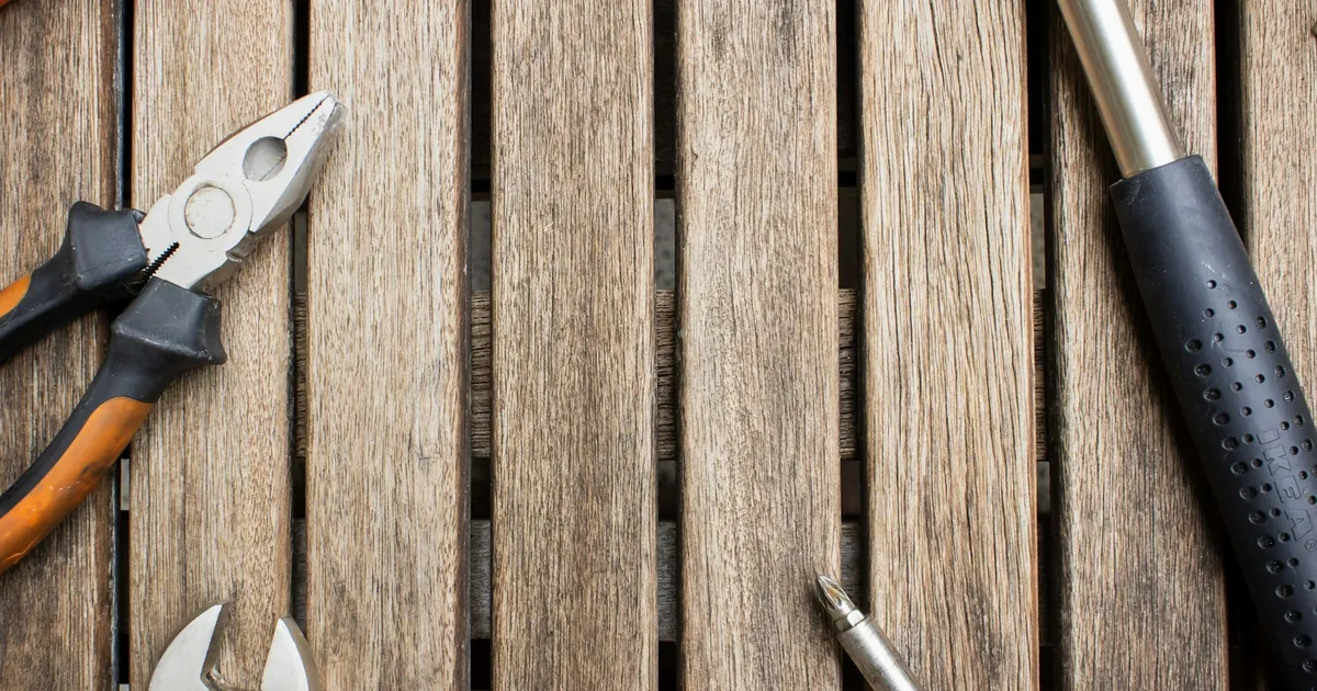 Hand tools arranged on weathered wooden slats